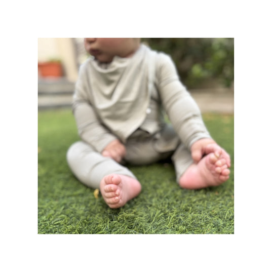 Sahe magnetic baby bamboo bibs - lifestyle baby with sage onesie birdie front side