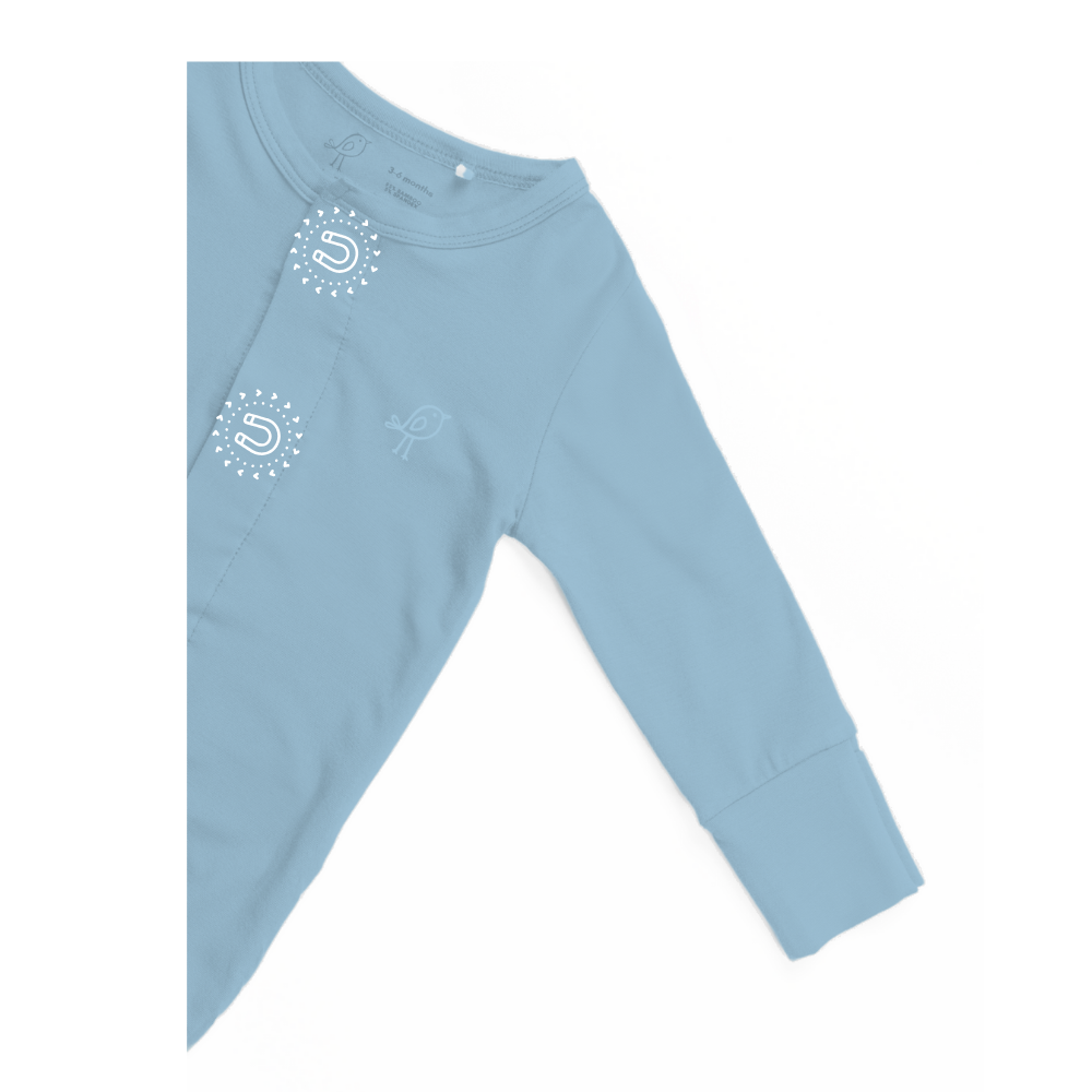 Birdie terracotta sleepsuit pyjama showing soft sleeve and embroidered bird logo and closeup magnetic closure
