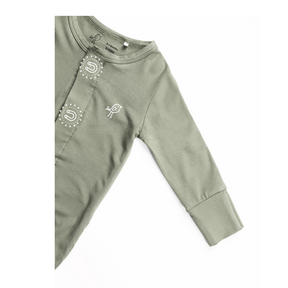 Birdie sage green sleepsuit showing soft sleeve and embroidered bird logo and magnetic closure closeup