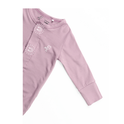 Birdie pink sleepsuit showing soft sleeve and embroidered bird logo and magnetic closure