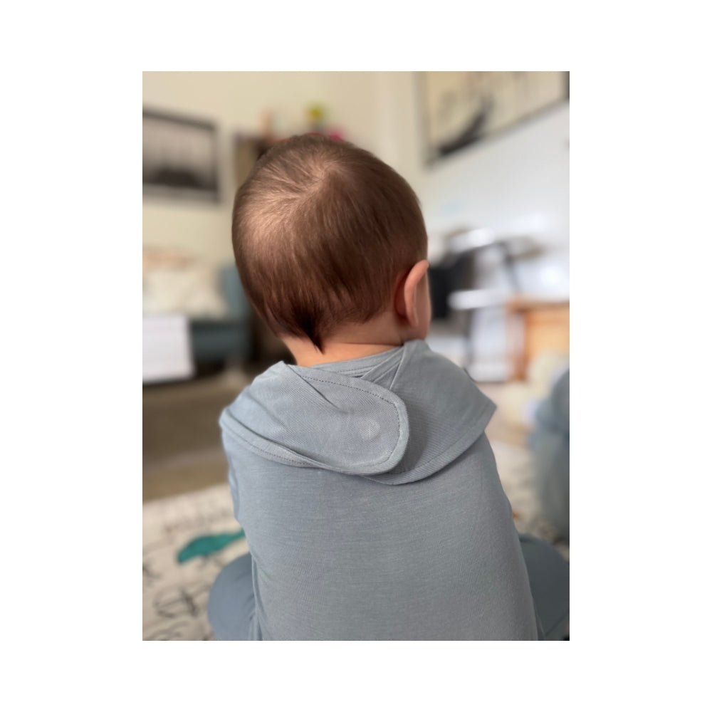 Blue magnetic baby bamboo bib - lifestyle photo on baby model back side