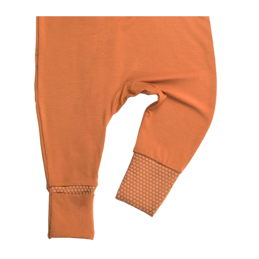Birdie terracotta orange baby sleepsuit with close-up of anti-slip foot grip convertible